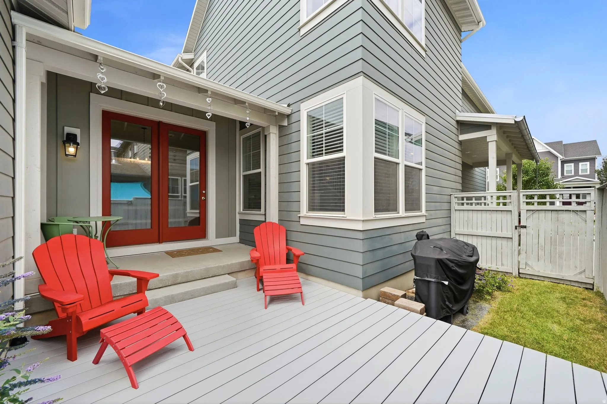 Outdoor deck space featuring light-colored decking and a covered porch area