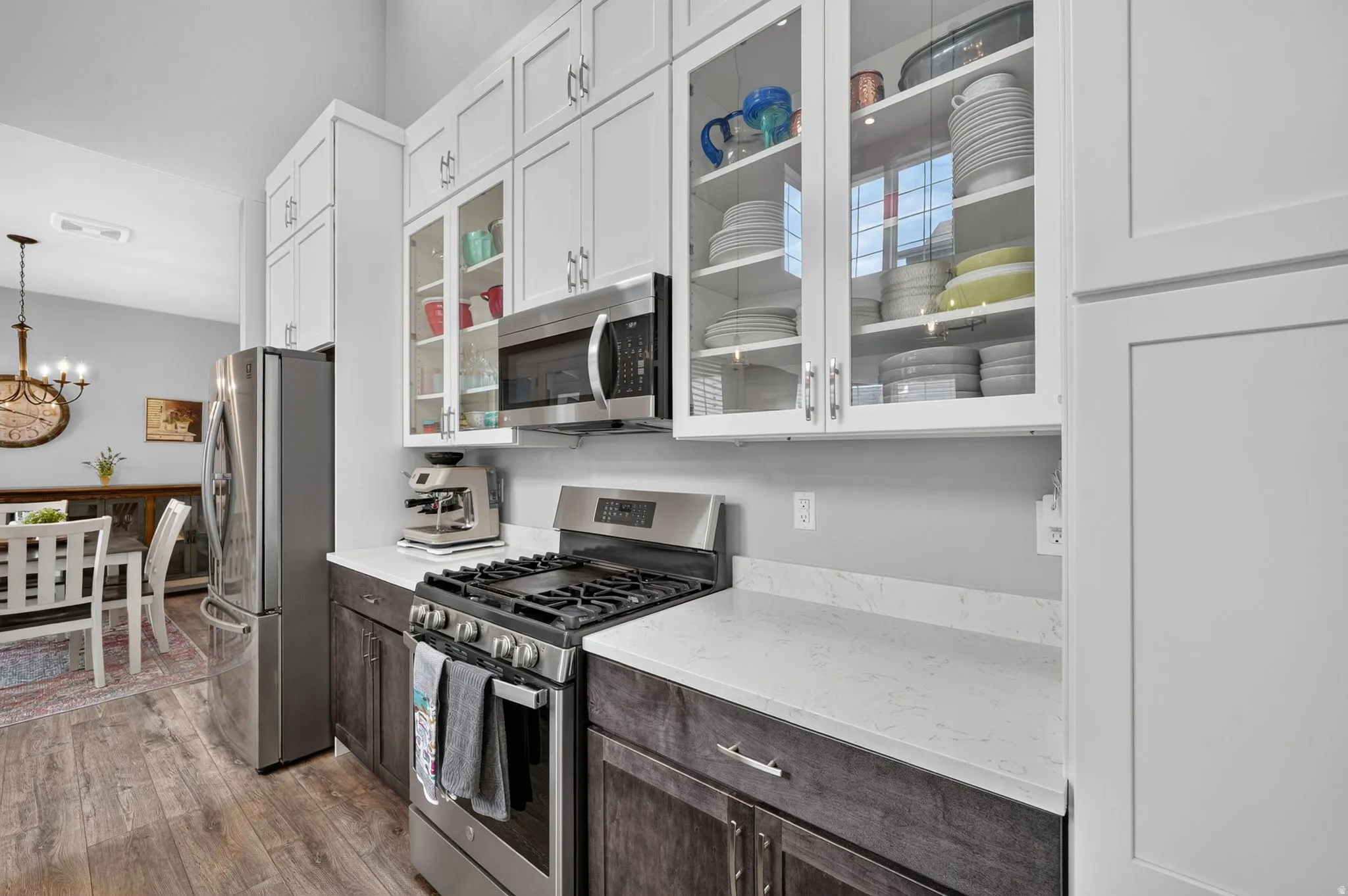 Modern kitchen featuring two-tone cabinetry, stainless steel appliances, and white countertops