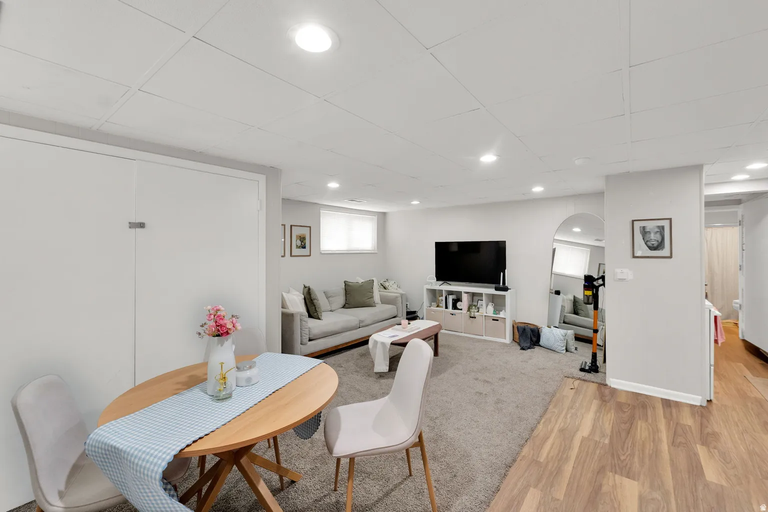 Finished basement with recessed lighting and a mixed flooring of carpet and wood-finish