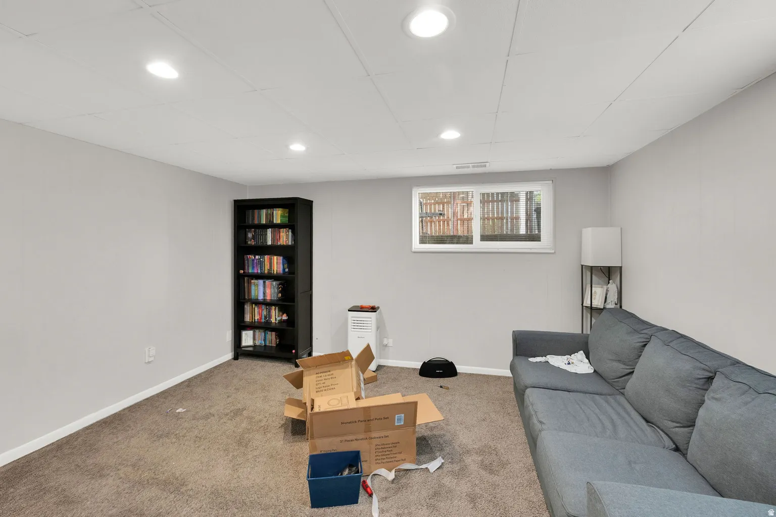 Finished basement area featuring recessed lighting, a drop ceiling, and neutral-toned walls