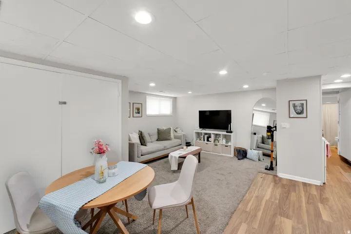 Finished basement with recessed lighting and a mixed flooring of carpet and wood-finish