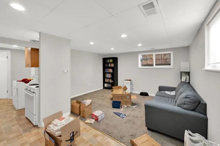Finished basement with light gray walls, recessed lighting, and a drop ceiling