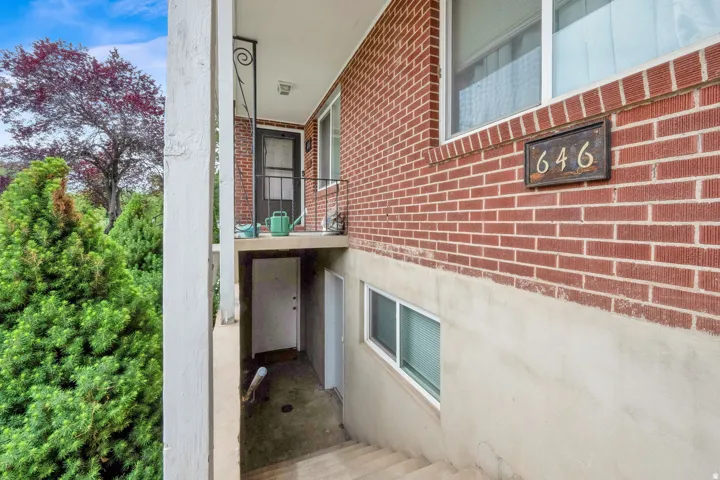 Red brick facade with a concrete foundation