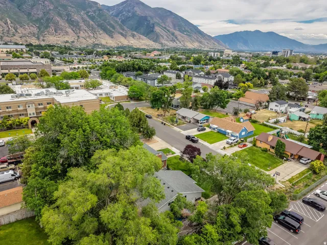 Aerial perspective showcasing a neighborhood with varied residential structures and mature trees