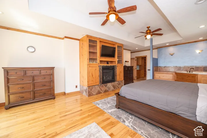 Hardwood flooring with a central area rug and a built-in entertainment center featuring a fireplace