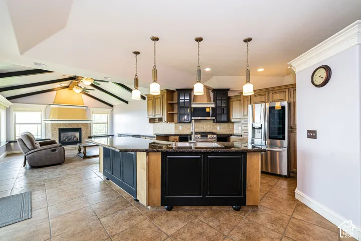 Spacious open-concept kitchen and living area featuring a large center island with pendant lighting