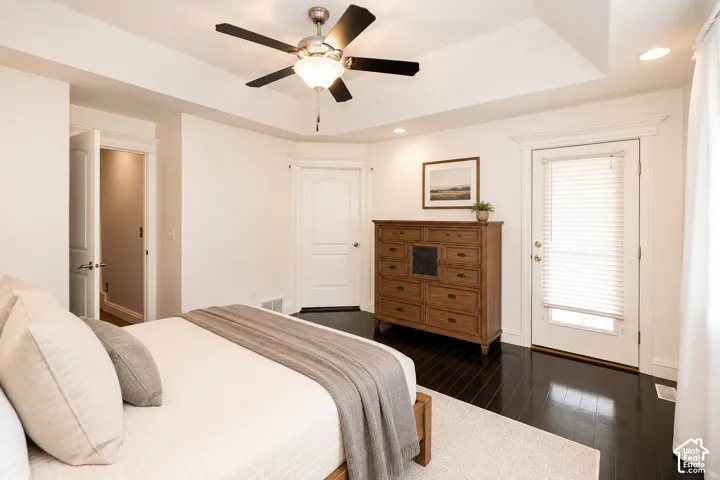 Recessed lighting illuminating a spacious room with dark wood-finish flooring