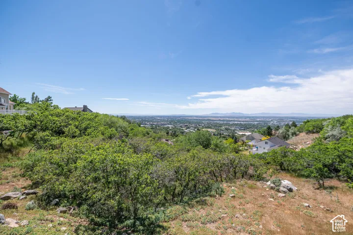 Expansive natural landscape featuring varied terrain, mature trees, and distant city and mountain scenery. Panoramic views, nightly west facing sunsets every night.