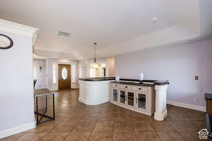 Spacious entryway featuring a decorative oval glass front door and tile flooring