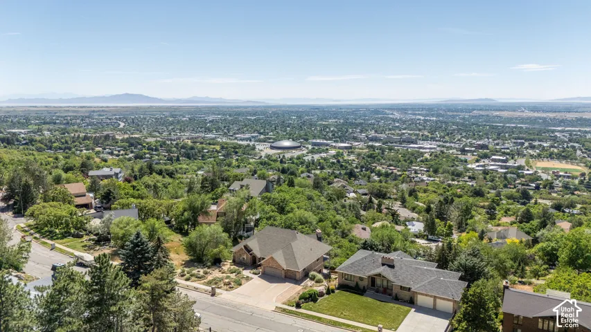 Expansive city panorama featuring a distant mountain range and a large domed structure