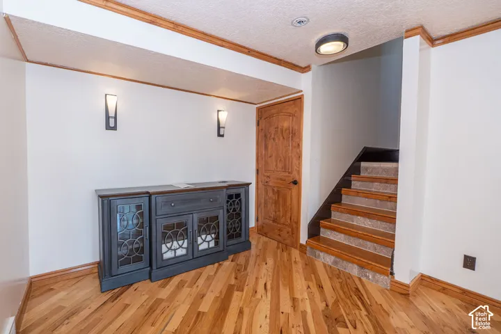 Warm wood-finish flooring with coordinating wood trim and door