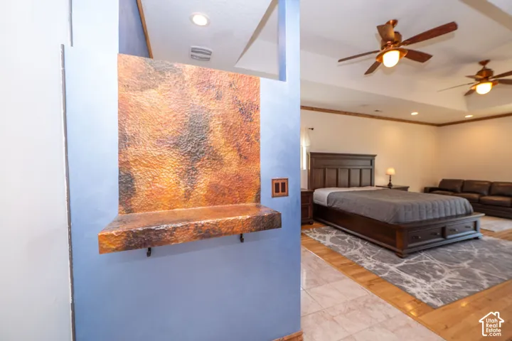 Level 2 Spacious Master Bedroom featuring dual ceiling fans with integrated lighting and recessed ceiling lights, built in fireplace and a private walk out.
