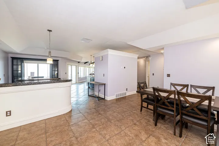 Open-concept dining and kitchen area featuring tile flooring throughout