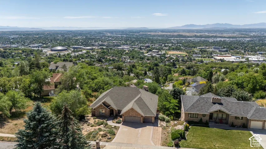 Aerial perspective showcasing a residential property with an expansive surrounding landscape