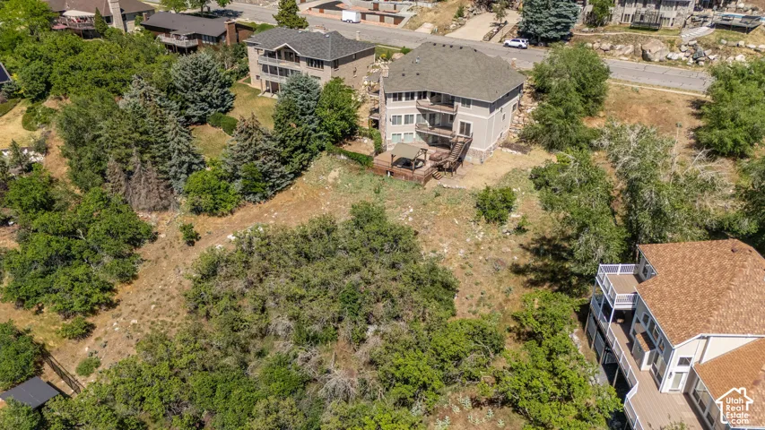 Multi-level residence featuring a light gray exterior, a dark shingle roof, and multiple balconies