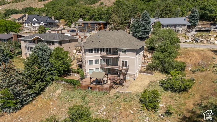 Multi-story residence featuring a gray shingle roof and balconies