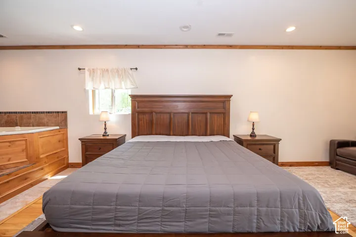 Room featuring a built-in spa tub with tiled surround and wood-finish paneling