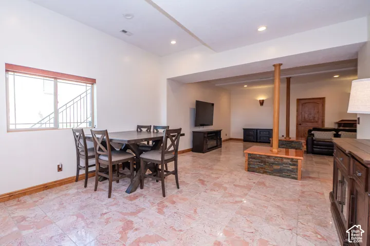 Spacious dining room featuring polished tile flooring and recessed lighting