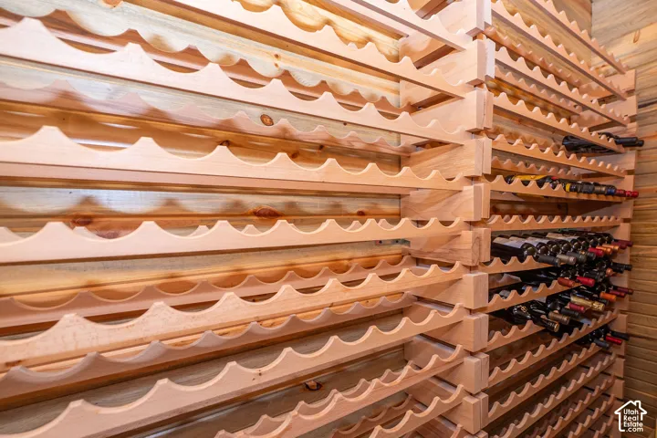 Custom-built wood wine racks featuring a scalloped design. Sits up to 400 bottles.