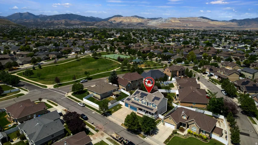 Aerial perspective highlighting a residential neighborhood with distant mountains