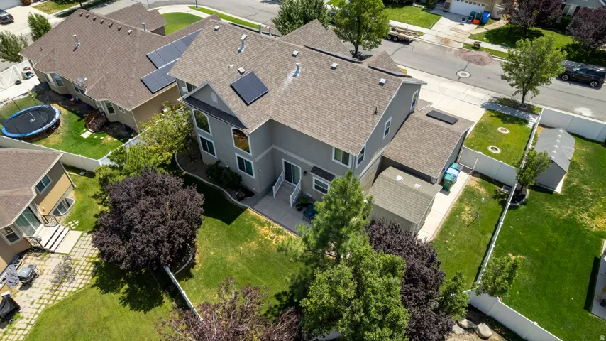 Two-story residence featuring a gray exterior siding and a brown shingle roof