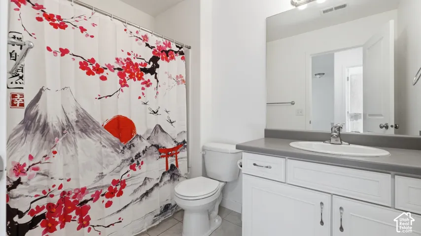 Bathroom featuring a white vanity with a gray countertop, an integrated sink, and chrome fixtures