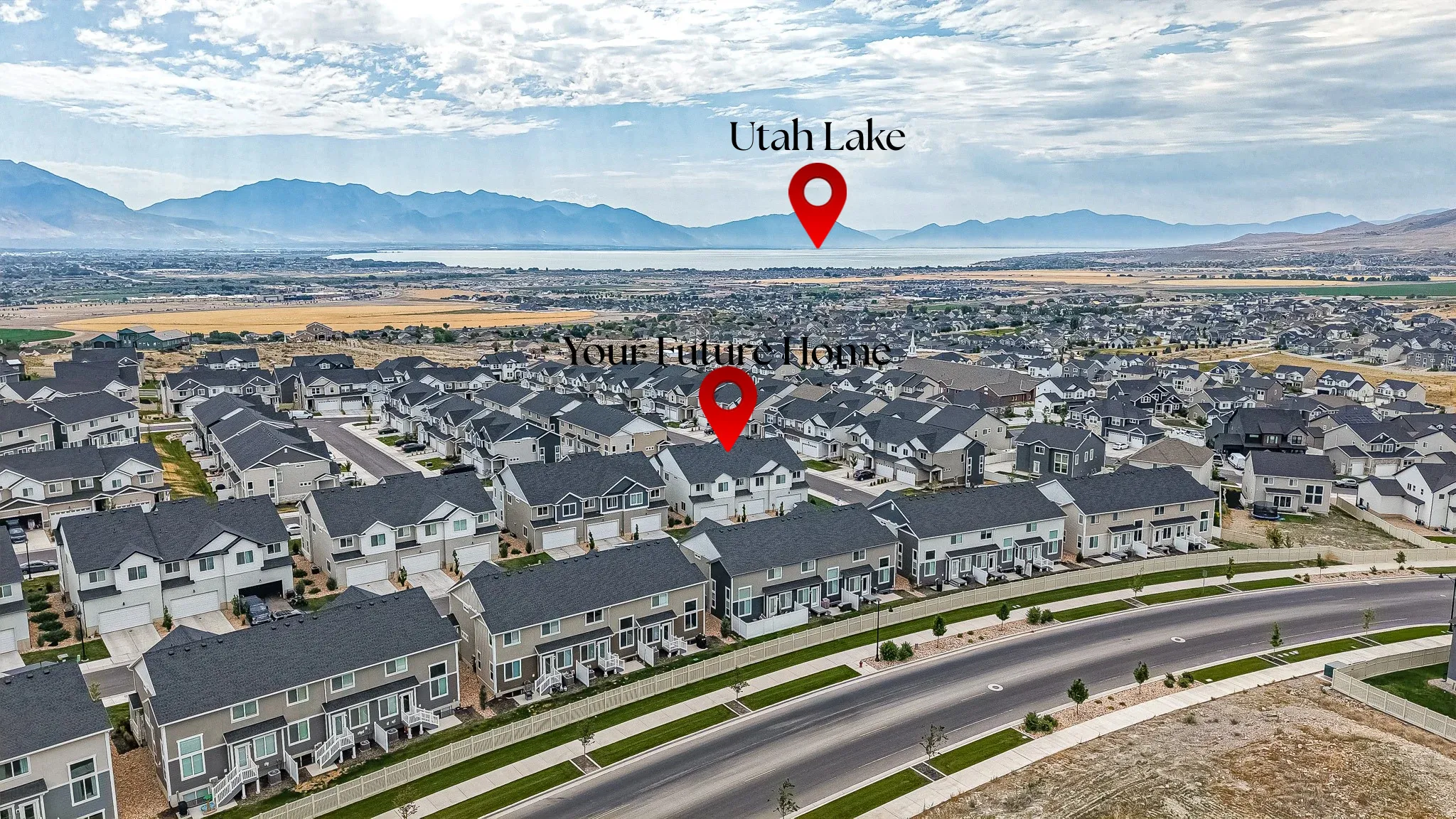 Newly developed residential community featuring a variety of housing styles, established roadways, and distant mountain and lake scenery