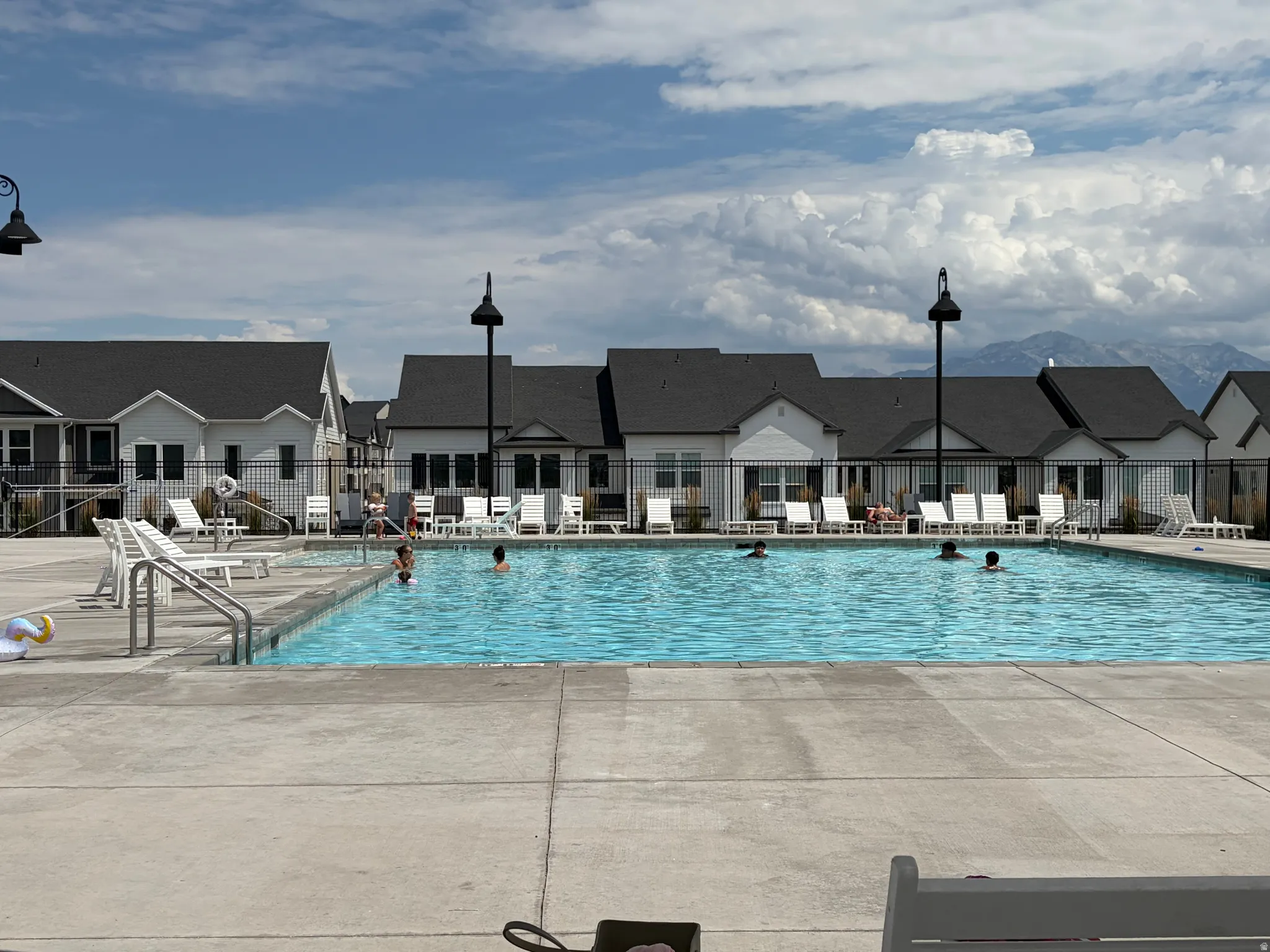 Expansive outdoor swimming pool with concrete decking