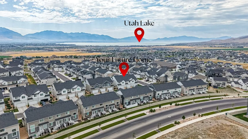 Newly developed residential community featuring a variety of housing styles, established roadways, and distant mountain and lake scenery