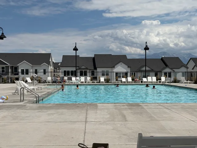Expansive outdoor swimming pool with concrete decking