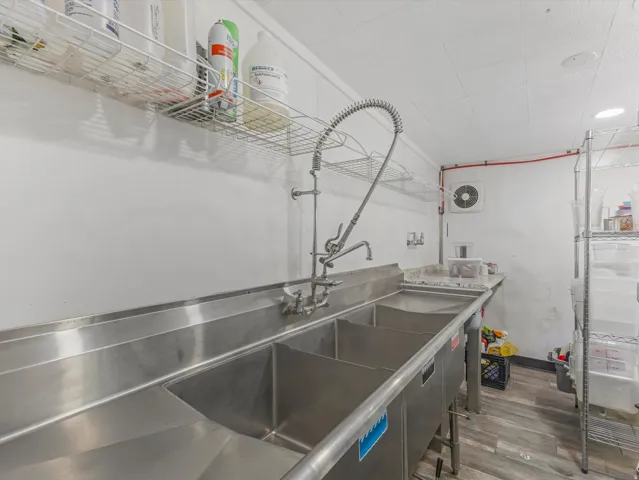 Stainless steel triple basin sink with a high-arc commercial faucet