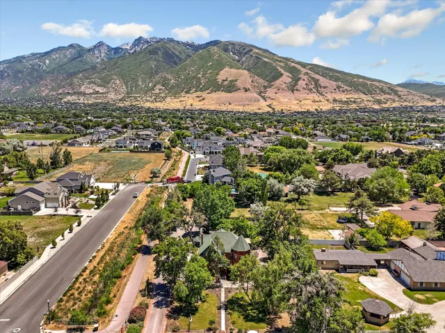 Expansive mountain backdrop with a residential area featuring established homes and open land
