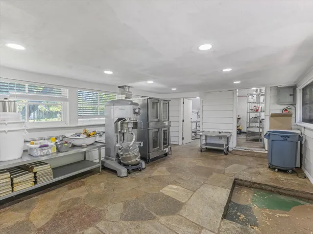 Spacious room with flagstone flooring and recessed lighting
