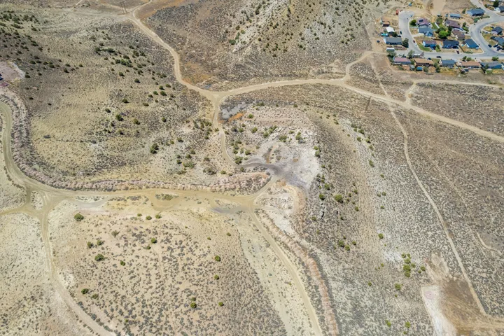 Expansive undeveloped land featuring diverse topographical elements and natural vegetation