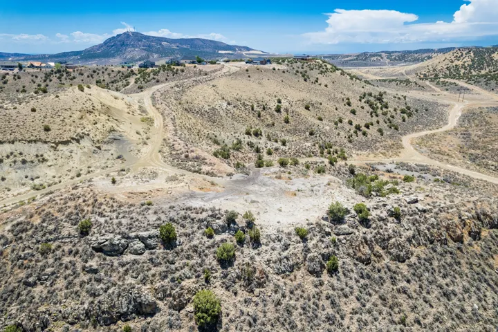 Vast expanse of undeveloped land featuring varied terrain, natural rock formations, and sparse vegetation