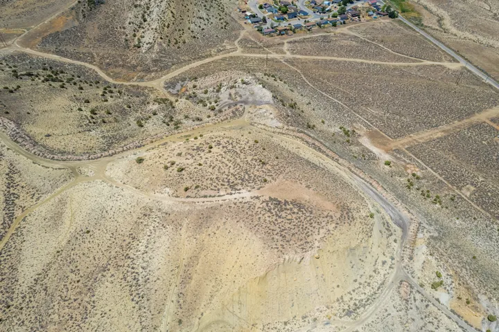 Expansive arid landscape featuring natural terrain and established dirt paths