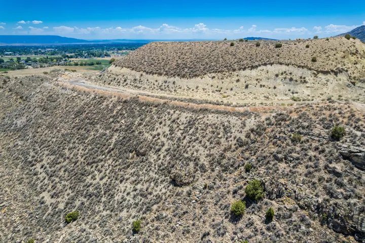 Expansive undeveloped land featuring diverse terrain and natural vegetation, offering abundant potential