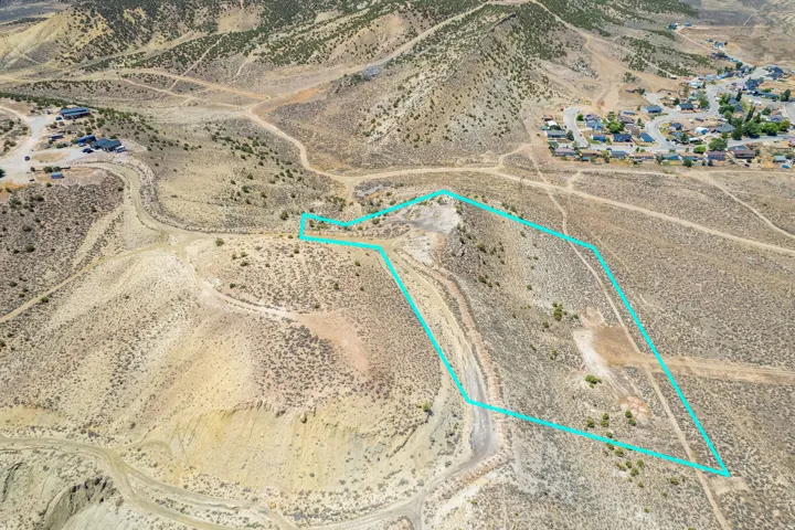 Expansive undeveloped land parcel featuring diverse topography with clear boundary lines