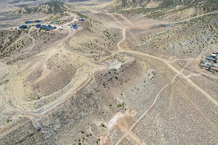 Expansive desert landscape featuring rolling hills and natural topography