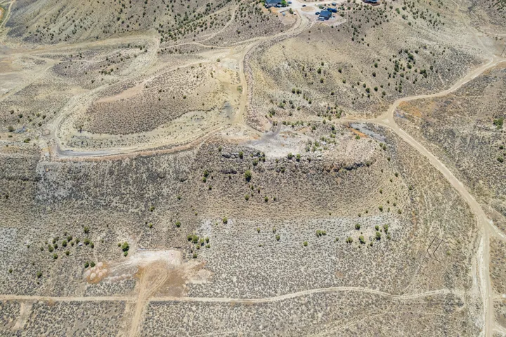Expansive desert terrain featuring varied elevation changes, natural rock formations, and sparse vegetation