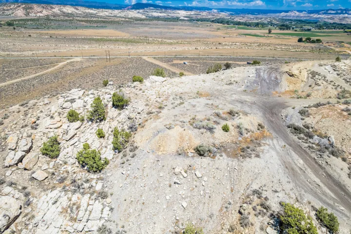 Elevated terrain featuring rocky outcroppings and scattered shrubs
