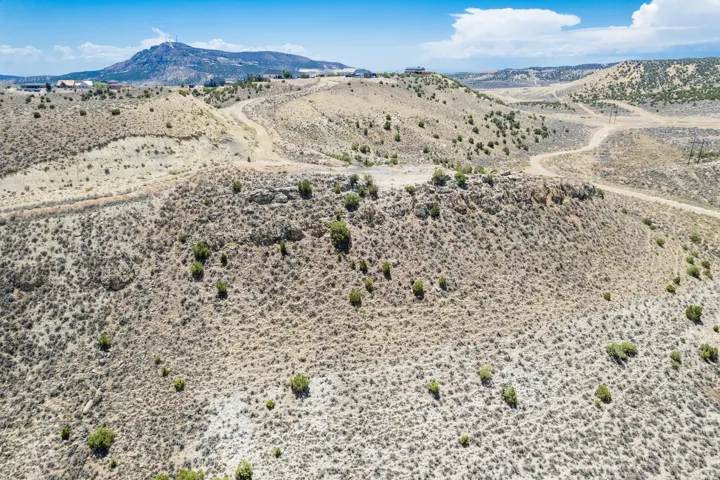 Expansive natural landscape featuring undulating terrain and sparse vegetation