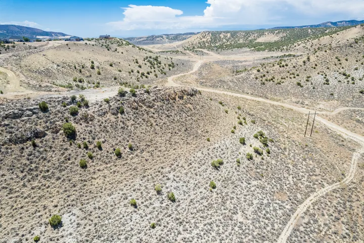 Expansive desert landscape featuring rolling hills and natural vegetation