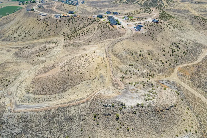 Expansive undeveloped terrain featuring established dirt roads and scattered natural vegetation