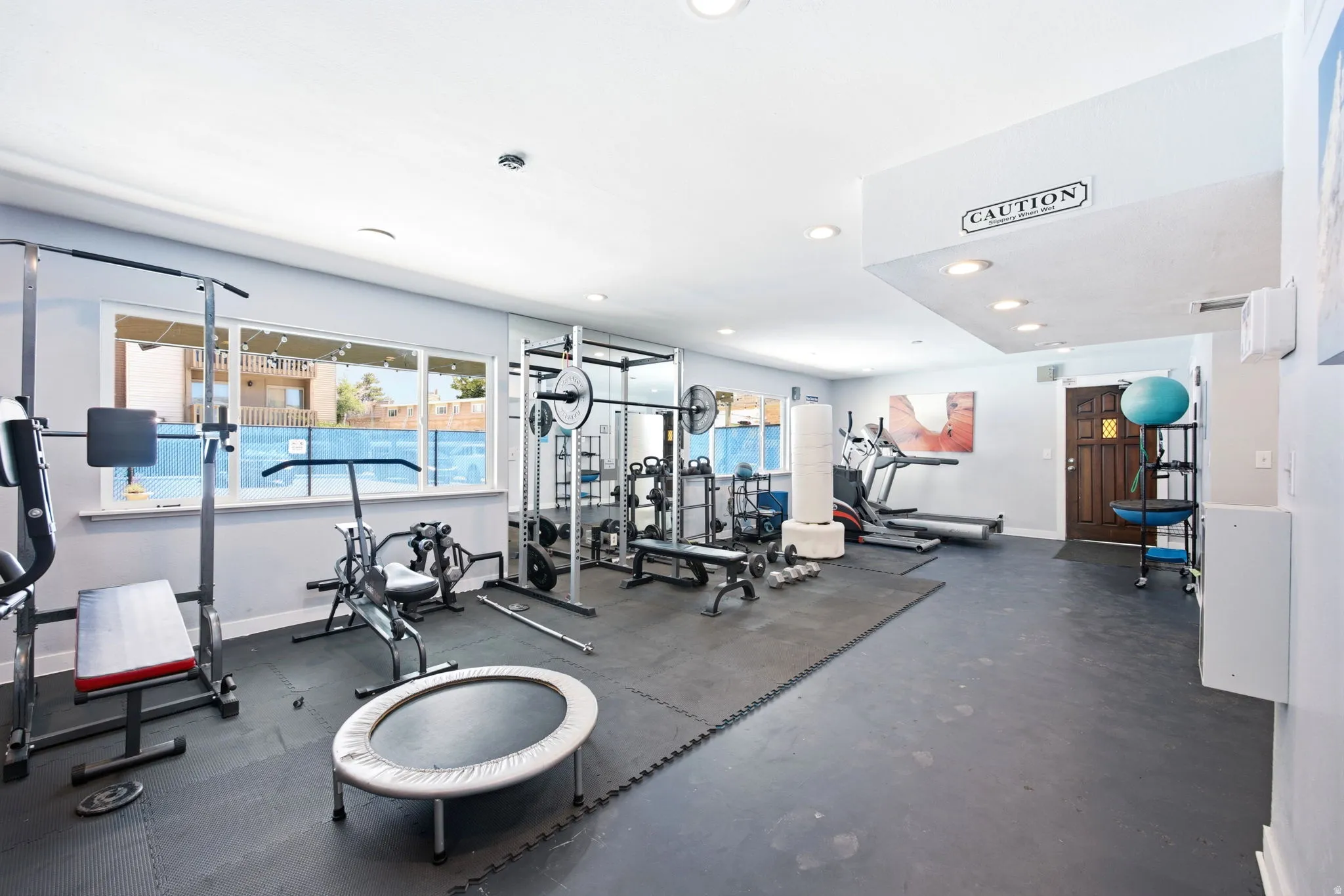 Dedicated fitness room featuring rubberized flooring and expansive windows