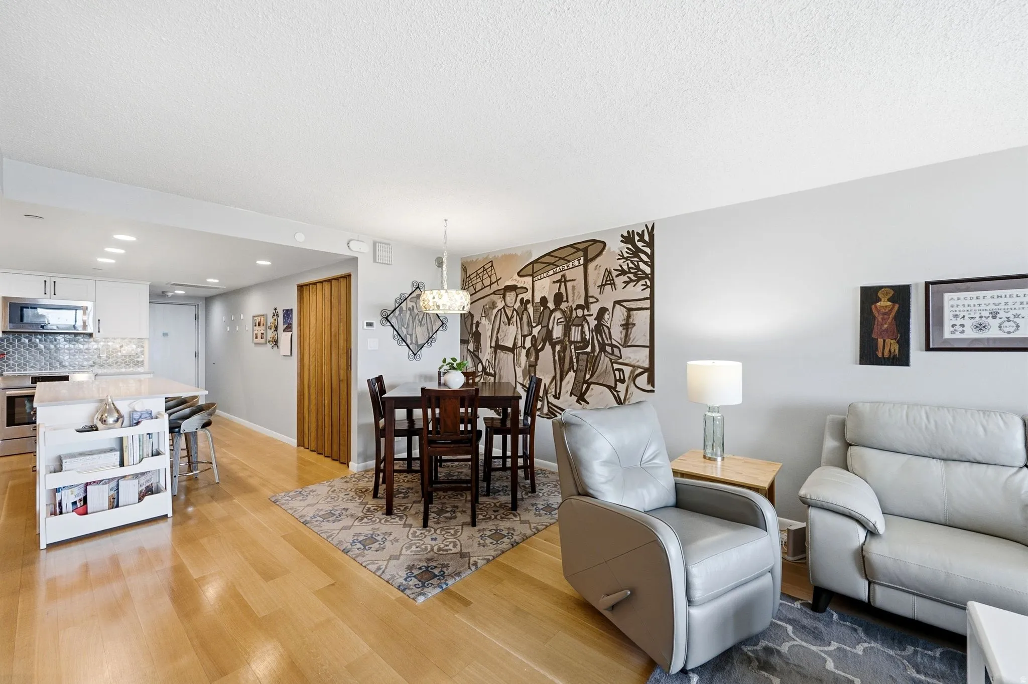 Open-concept living area featuring light wood-finish flooring