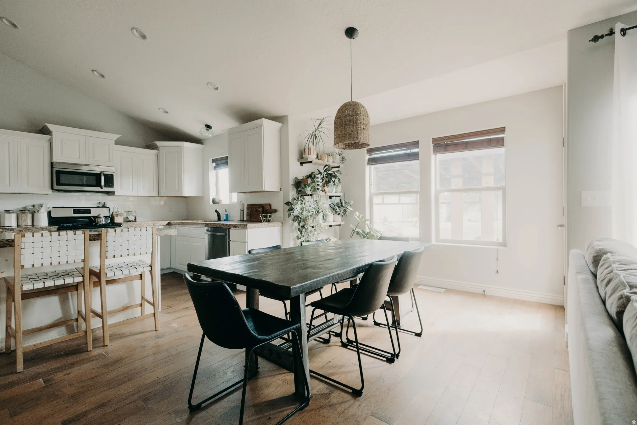 Open-concept living space with vaulted ceilings and wood-finish flooring