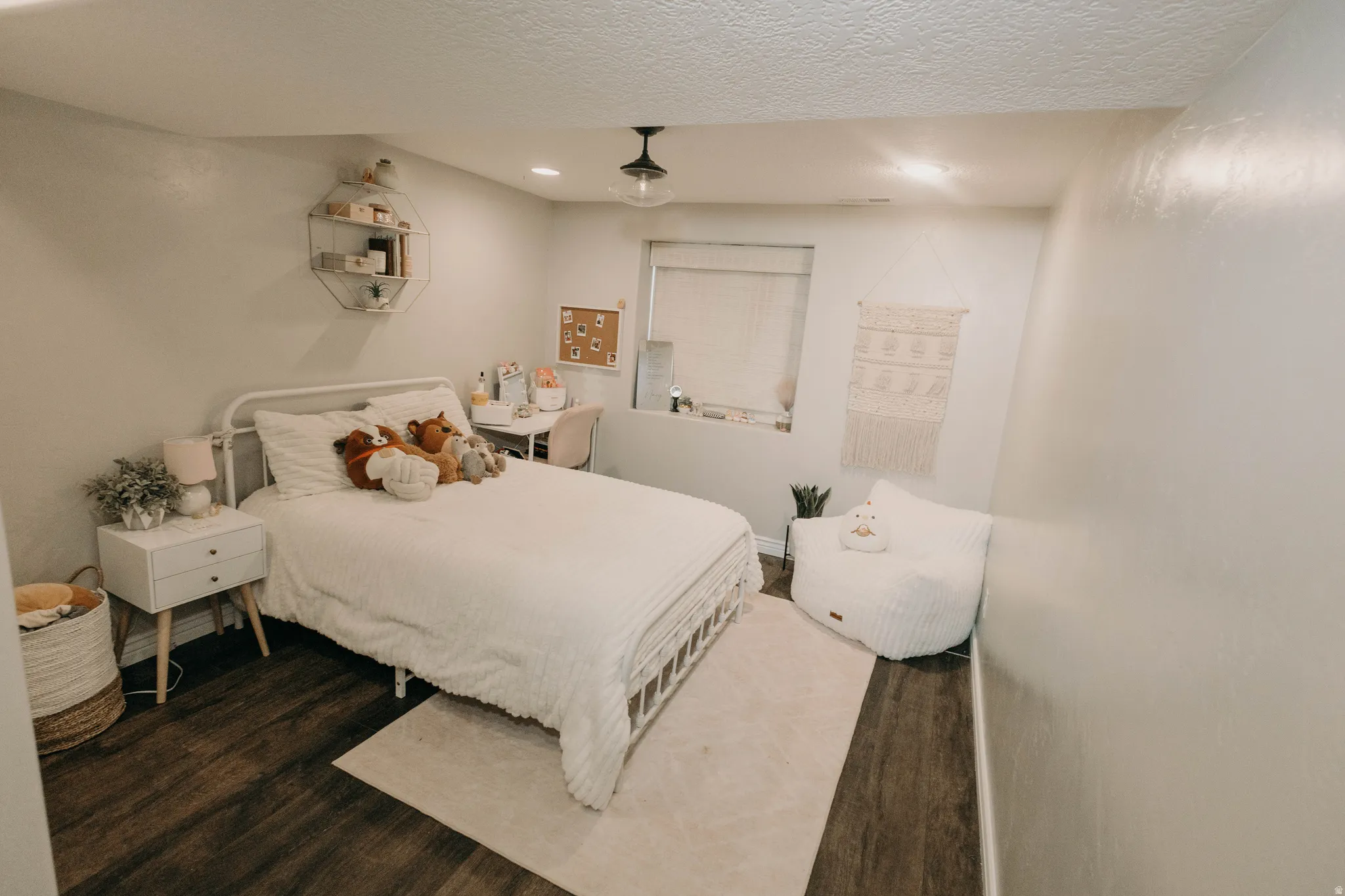 Bedroom featuring dark wood-finish flooring and light-toned walls
