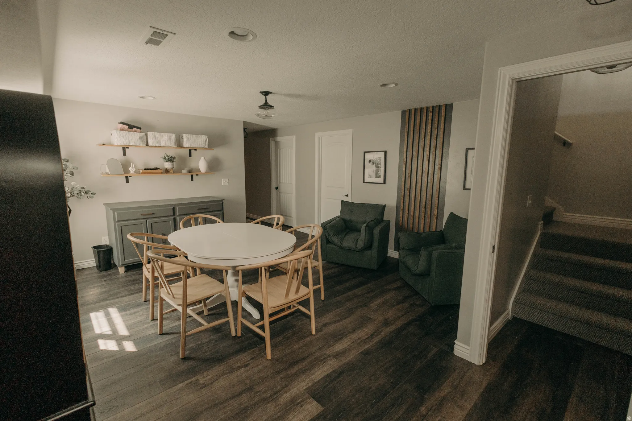 Spacious interior featuring wood-finish flooring, recessed lighting, and a built-in wall unit with shelving