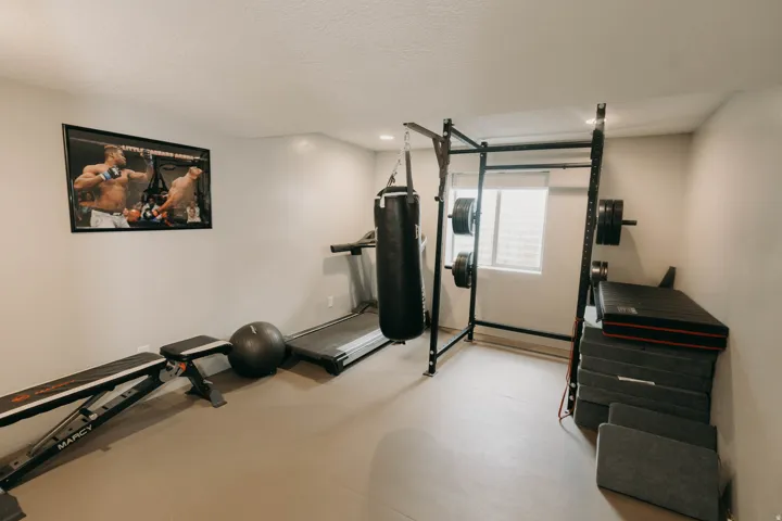 Dedicated fitness room featuring light gray walls and a window with blinds